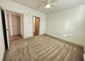 Thumbnail 28 of 46 - the living room of an empty house with a ceiling fan