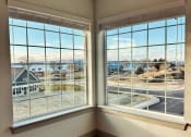 Thumbnail 27 of 46 - a corner window with a view of a building and a street
