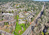 Thumbnail 15 of 50 - A road runs through a residential area with houses on both sides.