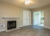 Thumbnail 3 of 36 - Three Bedroom | Living Room with Fireplace and Patio