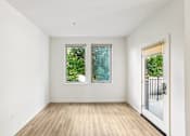 Thumbnail 53 of 59 - A room with wooden floors and two windows.