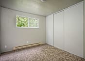 Thumbnail 17 of 22 - A room with a window, a bench, and a wall with a switch.