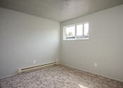 Thumbnail 12 of 22 - A room with a window and a carpeted floor.