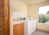 Thumbnail 10 of 22 - A laundry room with a washer and dryer.