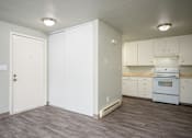 Thumbnail 16 of 22 - A kitchen with white cabinets and a white oven.