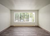 Thumbnail 21 of 22 - A room with a window and a wooden floor.