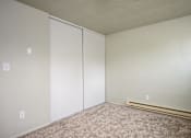 Thumbnail 20 of 22 - A room with a carpeted floor and a white door.