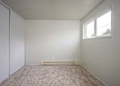 Thumbnail 19 of 22 - A room with a carpeted floor and a window.