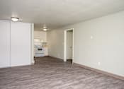 Thumbnail 8 of 22 - A kitchen with white cabinets and a white oven is visible through a doorway.