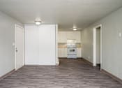 Thumbnail 4 of 22 - A kitchen with white cabinets and appliances is shown.
