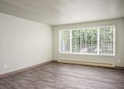 Thumbnail 18 of 22 - A room with a window and a wooden floor.