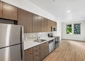 Thumbnail 50 of 59 - A modern kitchen with wooden cabinets and stainless steel appliances.