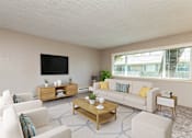 Thumbnail 2 of 34 - a living room with a couch and a table