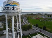 Thumbnail 45 of 46 - an aerial view of a water tower overlooking a highway and the ocean