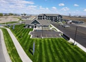 Thumbnail 44 of 46 - an aerial view of a parking lot with a building in the background