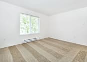 Thumbnail 14 of 24 - A room with a striped carpet and a window.