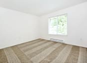Thumbnail 16 of 24 - A room with a striped carpet and a window.