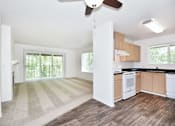 Thumbnail 10 of 24 - A kitchen with white cabinets and a striped rug on the floor.