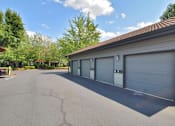 Thumbnail 23 of 24 - A residential building with a grey garage door.