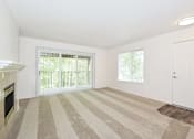 Thumbnail 7 of 24 - A room with a fireplace and striped carpet.