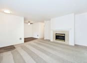 Thumbnail 5 of 24 - A room with a fireplace and striped carpet.