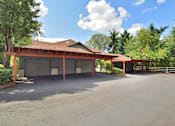 Thumbnail 21 of 24 - A large building with a red roof and a parking lot in front.