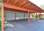 Thumbnail 22 of 24 - A covered parking area with two garage doors.