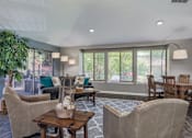Thumbnail 11 of 56 - a living room with couches and chairs and a dining room table