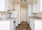 Thumbnail 48 of 56 - A kitchen with white appliances and cabinets.
