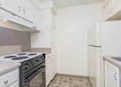 Thumbnail 18 of 56 - a kitchen with white cabinets and a stove and a refrigerator