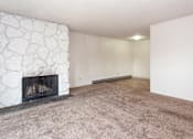 Thumbnail 2 of 40 - an empty living room with a fireplace and a carpeted floor