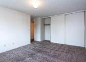 Thumbnail 23 of 40 - an empty living room with white walls and carpet