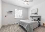Thumbnail 5 of 46 - a bedroom with a bed and a ceiling fan
