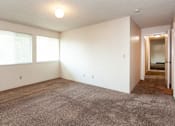 Thumbnail 4 of 40 - an empty living room with carpet and two windows
