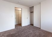 Thumbnail 6 of 40 - a room with a carpeted floor and a door to a closet