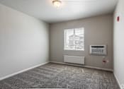 Thumbnail 10 of 48 - an empty room with a window and an air conditioner
