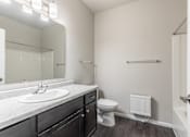 Thumbnail 7 of 48 - a bathroom with a large mirror and a sink and a toilet