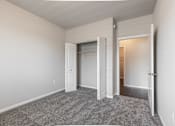 Thumbnail 9 of 48 - an empty bedroom with a closet and an open door
