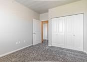 Thumbnail 2 of 48 - a bedroom with two closets and a door to a hallway