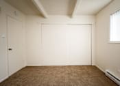 Thumbnail 25 of 26 - A room with a brown carpet and white walls.