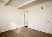 Thumbnail 24 of 26 - A room with a carpeted floor and a white door.