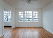 Thumbnail 15 of 52 - A room with wooden floors and a ceiling fan.
