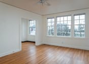 Thumbnail 4 of 52 - A room with a ceiling fan and two windows.