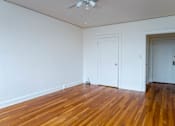 Thumbnail 5 of 52 - A room with a wooden floor and a ceiling fan.
