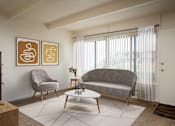 Thumbnail 17 of 26 - A living room with a grey couch, a grey armchair, a white coffee table, and two framed artworks on the wall.