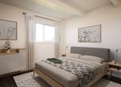 Thumbnail 9 of 26 - A bedroom with a large bed and a window with curtains.
