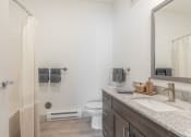 Thumbnail 12 of 46 - a bathroom with a sink and a toilet and a shower