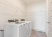 Thumbnail 13 of 46 - an empty laundry room with a washer and dryer in it