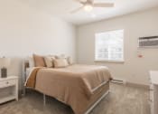 Thumbnail 9 of 46 - a bedroom with a bed and a ceiling fan