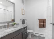 Thumbnail 6 of 46 - a bathroom with a sink and a toilet and a shower